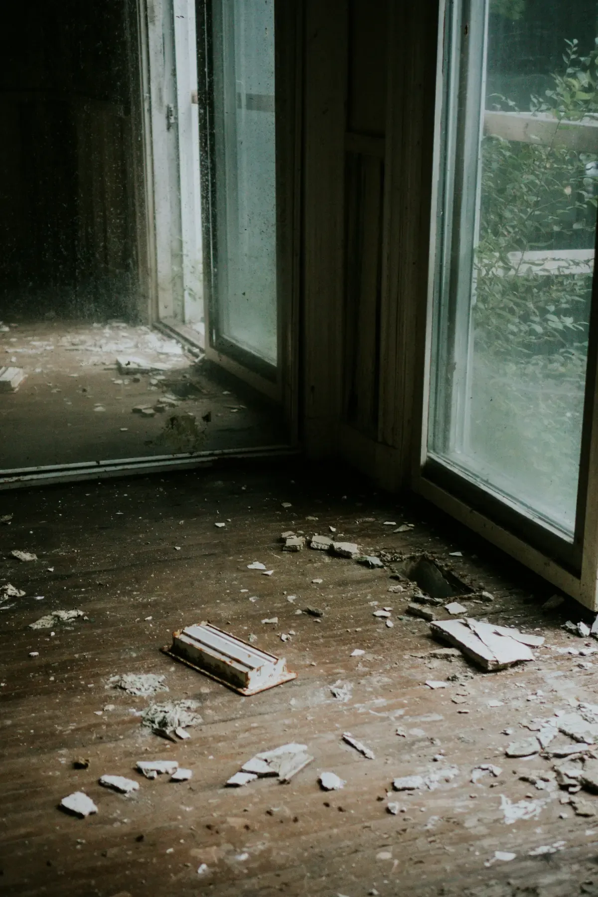 Broken window glass and debris after home damage
