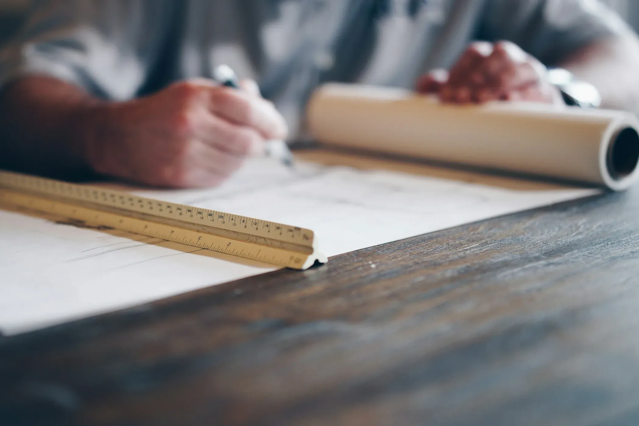 Residential construction plans and measuring tools on a work table