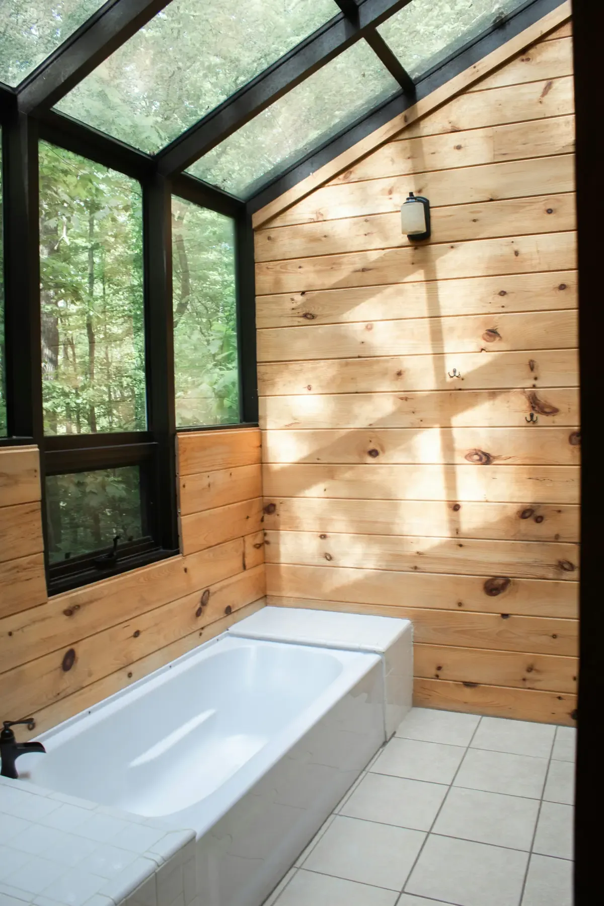 Bathroom restored after storm damage with repaired tub and window area